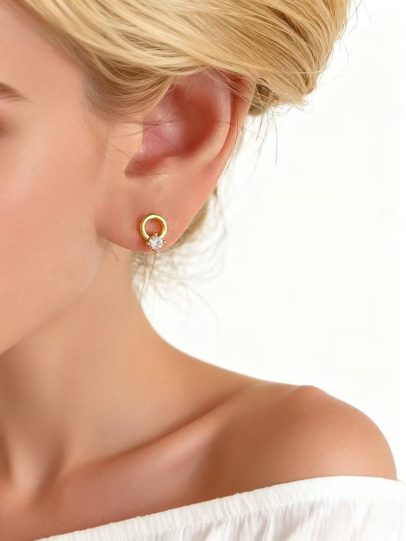 Original Aetheris Circle of Fortune gold huggie earring worn on an ear