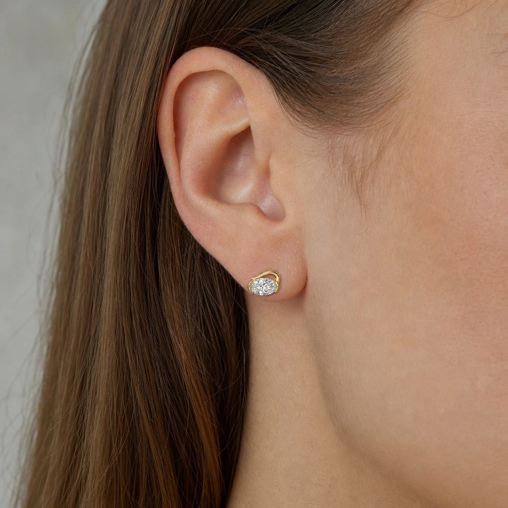 Aetheris Turning Crest Wave Studs, oval lab-grown diamond stud earrings, worn on the ear, side view